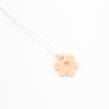 Necklace with a pink flower-shaped pendant on a white background