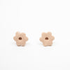 Two light pink flower-shaped beads on a white background