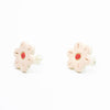 A photo of the rose stud earrings. Ceramic earrings with a flower shape and rose colour leaves with a red centre. Side view also shows sterling silver stud backings. 