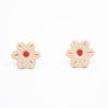 A photo of the rose stud earrings. Ceramic earrings with a flower shape and rose colour leaves with a red centre.