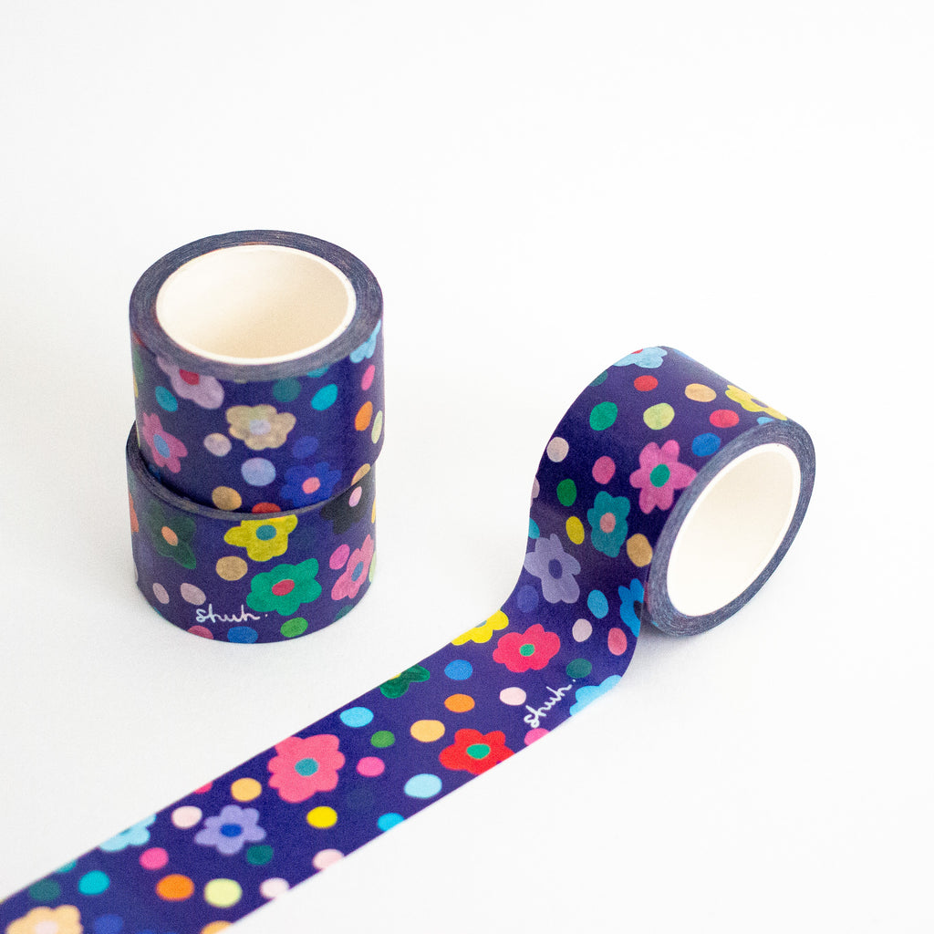 Washi tape with colourful floral and polka dot pattern on a white background