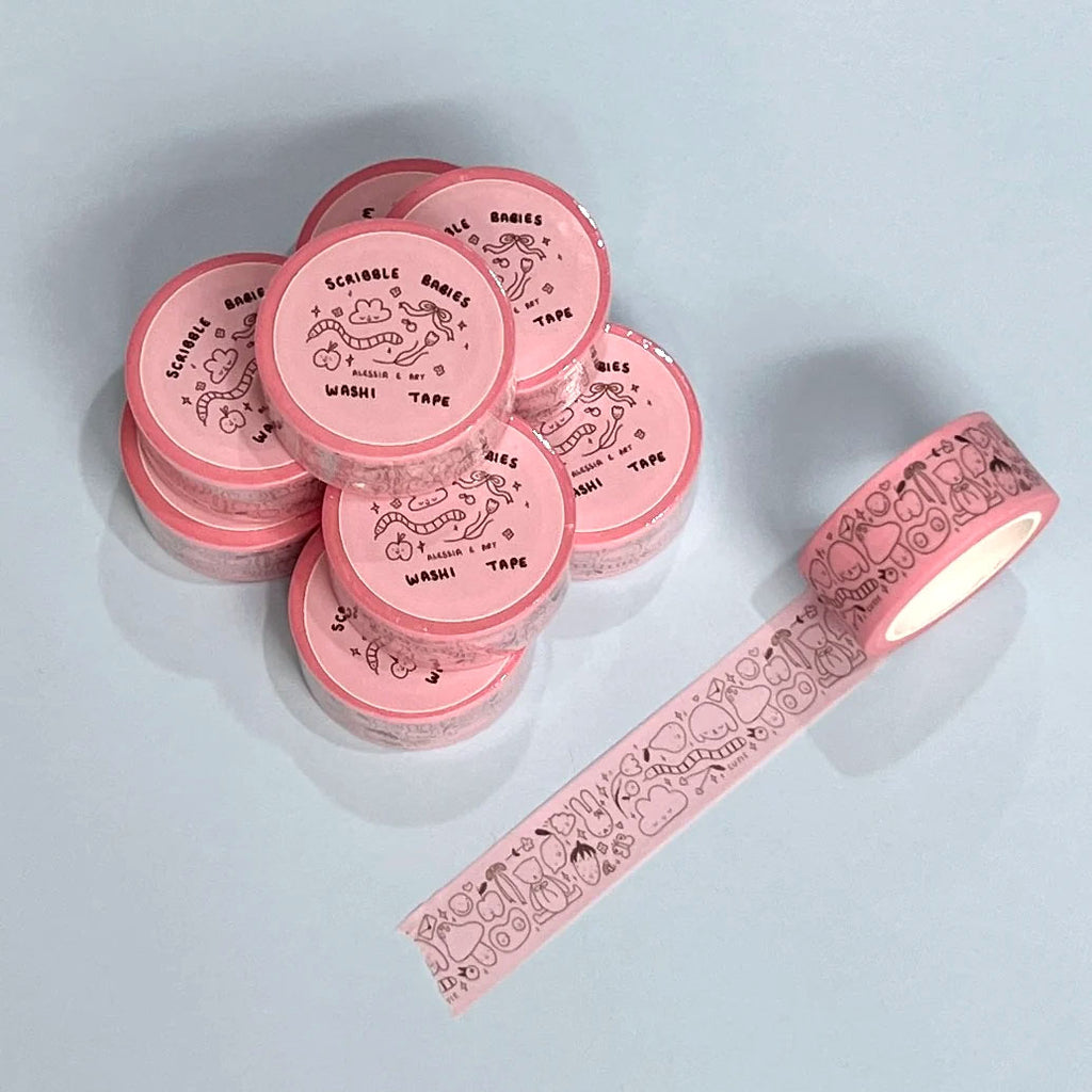 Pink washi tape with decorative designs on a light blue background