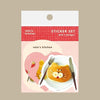 A cute sticker set from 'valo's kitchen' featuring three whimsical designs: a round plate-shaped sticker with a cat-shaped pancake, a pink heart-shaped sticker with a bunny displayed on a grey background.