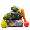 A Front view of the 3 bees wax food wraps. All are in use protecting food. There are fruits and vegetables around the wraps. 
