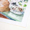 A close-up of a watercolour art print featuring a fluffy brown animal, white flowers in a vase, and green painted surfaces, with a white border and a faint artist signature near the bottom.