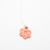 Pink flower pendant on a white background