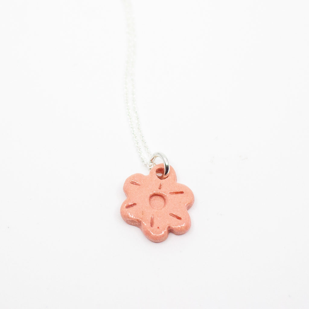 Pink flower pendant on a white background