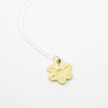 Necklace with a yellow flower-shaped pendant on a white background