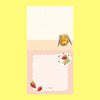 A small notepad with a cute cartoon food and animal illustration.