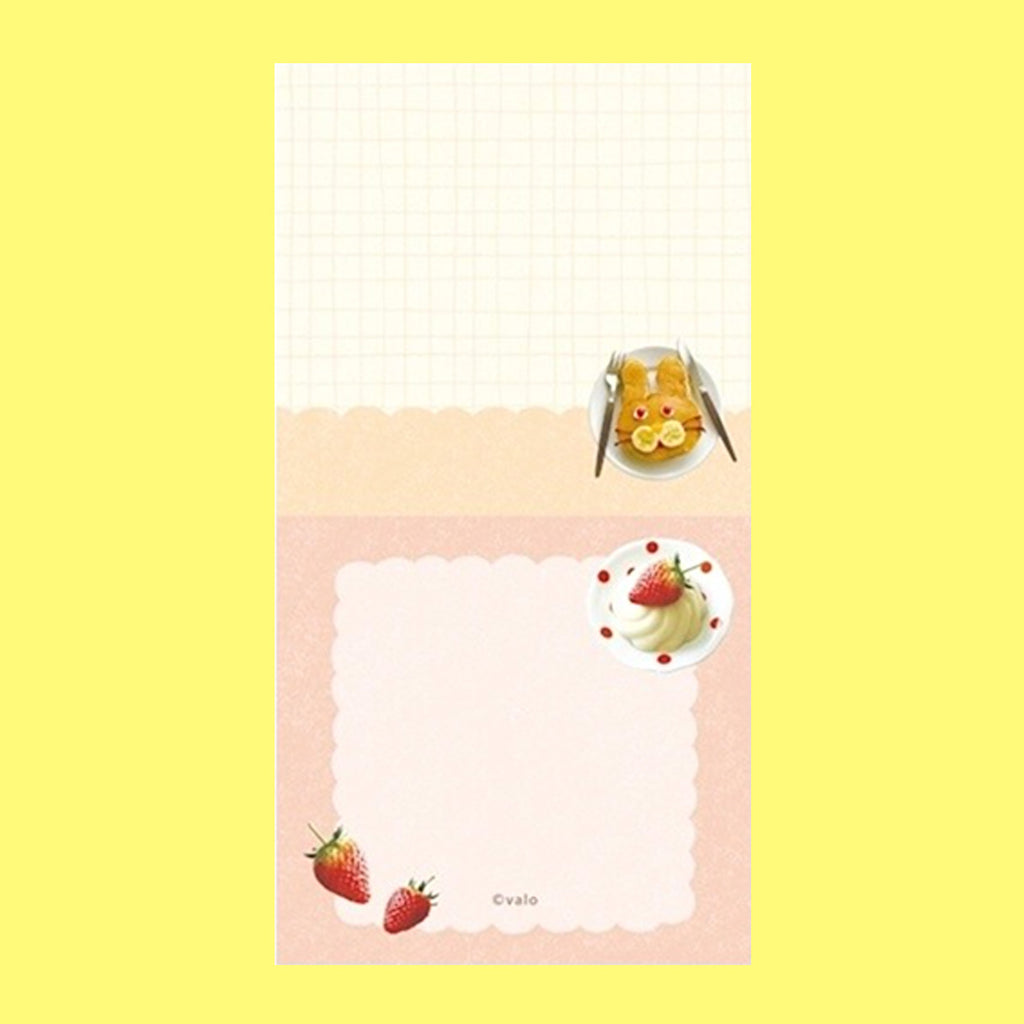 A small notepad with a cute cartoon food and animal illustration.