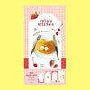 A small notepad with a cute cartoon food and animal illustration on the cover.