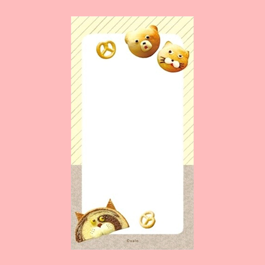 A small notepad with a cute cartoon food and animal illustration.