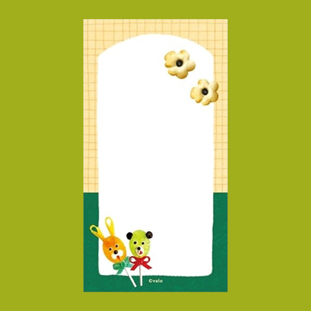 A small notepad with a cute cartoon food and animal illustration.