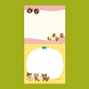 A small notepad with a cute cartoon food and animal illustration.
