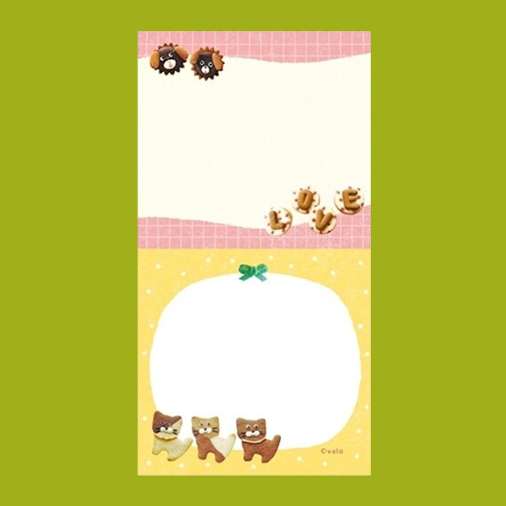 A small notepad with a cute cartoon food and animal illustration.