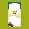 A small notepad with a cute cartoon food and animal illustration.
