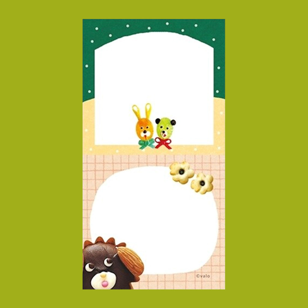 A small notepad with a cute cartoon food and animal illustration.
