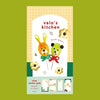 A small notepad with a cute cartoon food and animal illustration on the cover.
