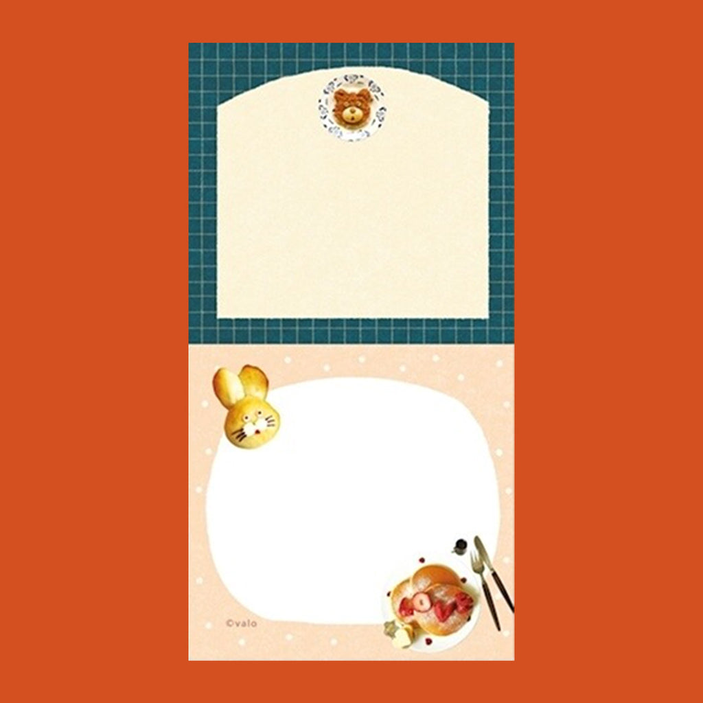A small notepad with a cute cartoon food and animal illustration.