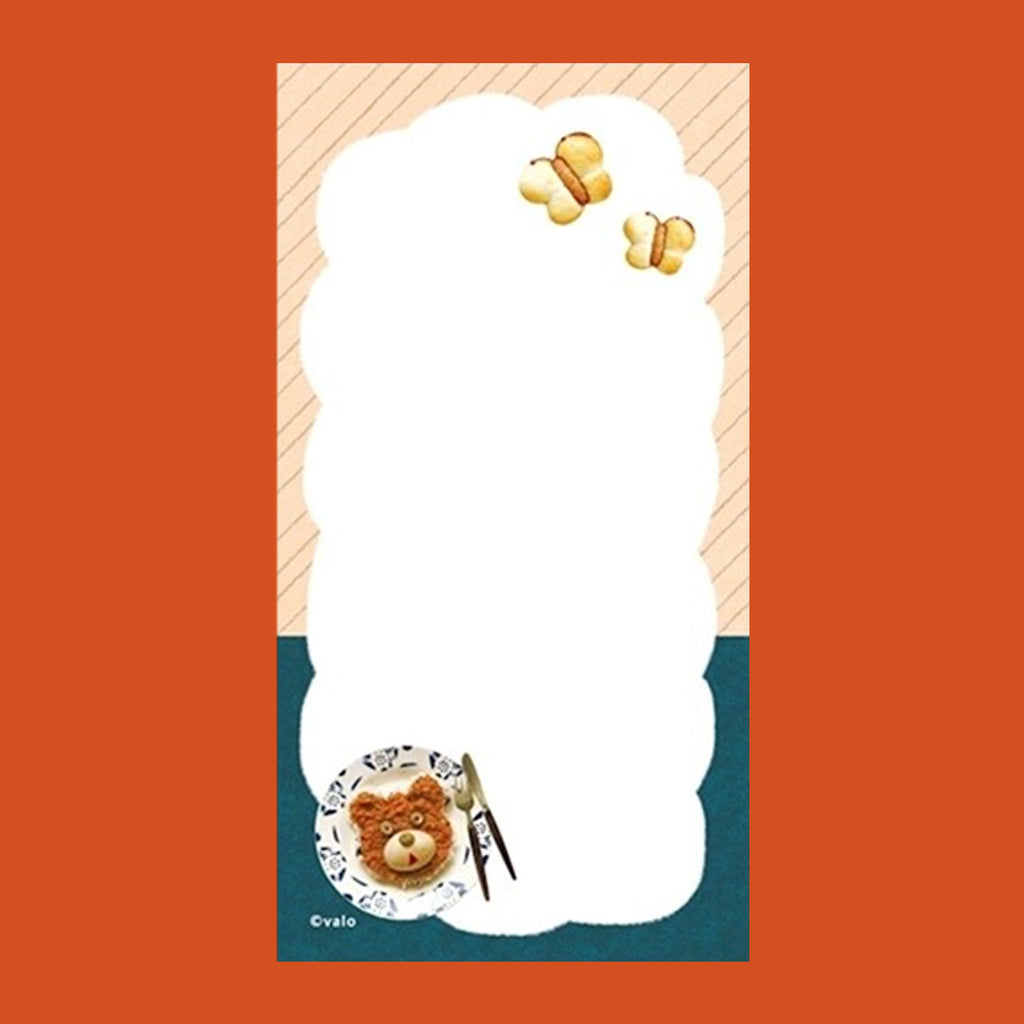 A small notepad with a cute cartoon food and animal illustration.