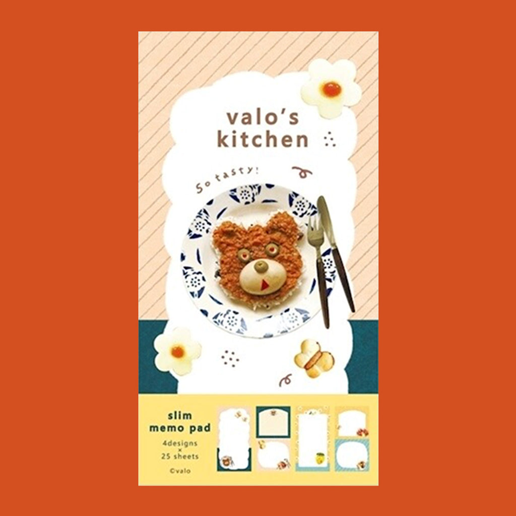 A small notepad with a cute cartoon food and animal illustration on the cover. 