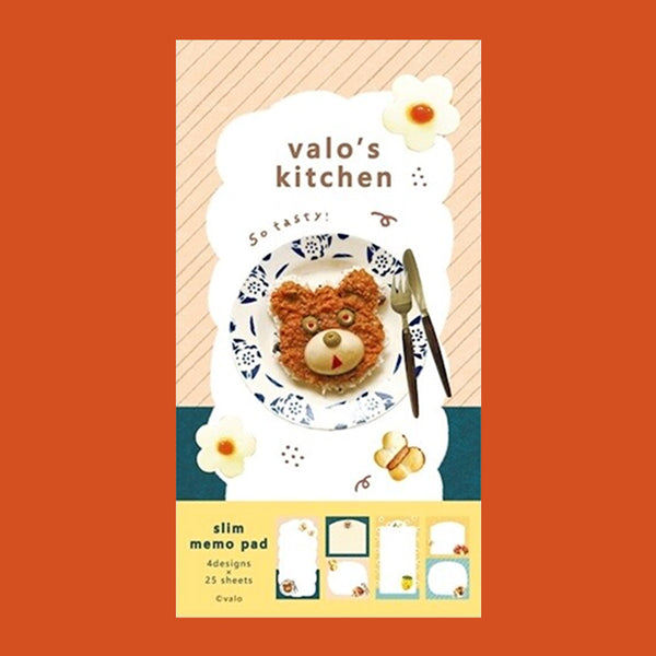 A small notepad with a cute cartoon food and animal illustration on the cover. 