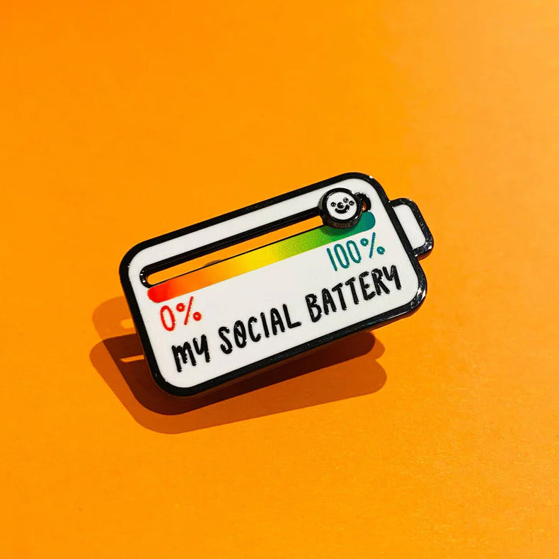 An enamel pin with my social battery letters with sliding feature