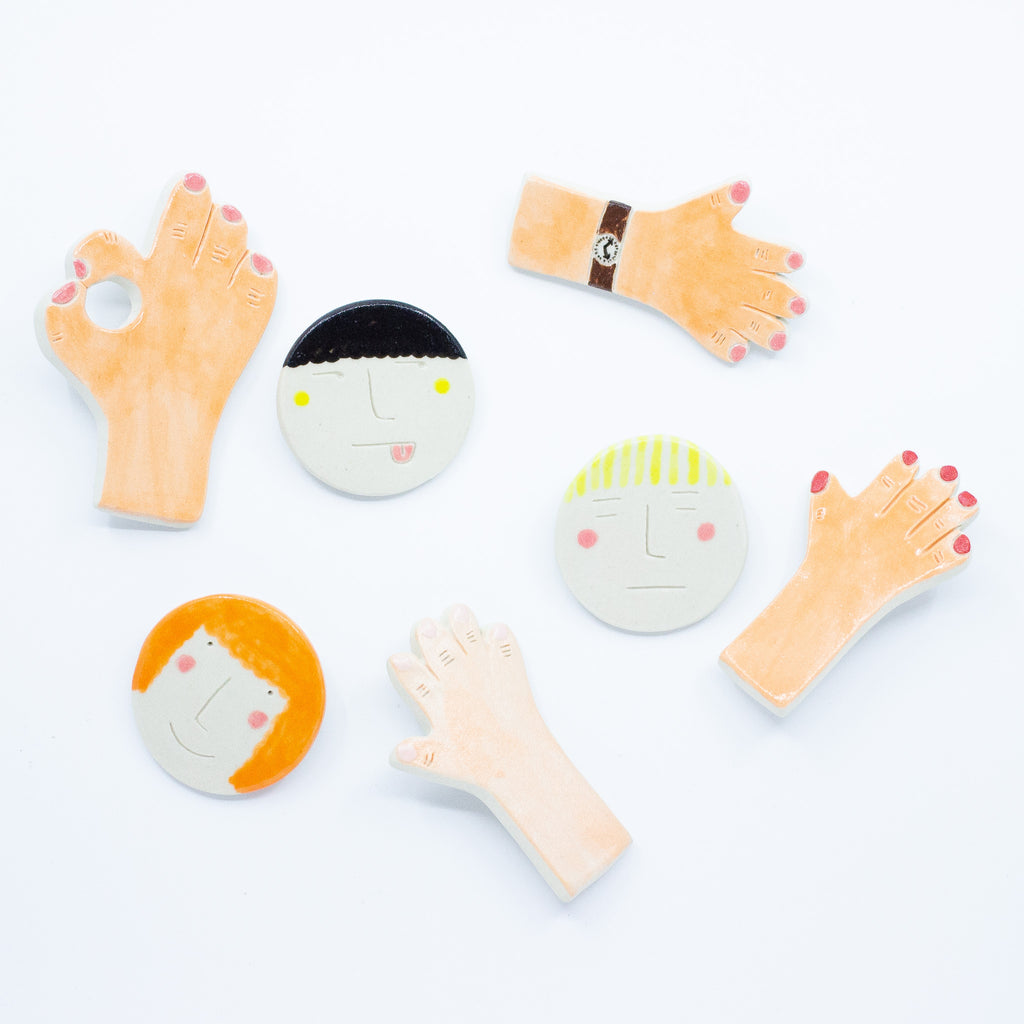 A top view of the social collection of ceramic brooches by shuh. 