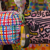 Two colorful bags with unique patterns on a multicolored background