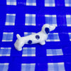 White dog figurine with blue spots on a blue checkered background