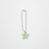 Star-shaped charm with a smiley face on a white background