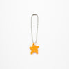 Orange star-shaped keychain on a silver chain against a white background