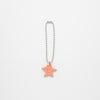 Keychain with a star-shaped pink charm on a white background
