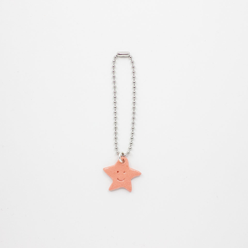 Keychain with a star-shaped pink charm on a white background
