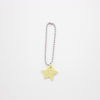 Star-shaped charm on a chain against a white background
