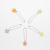 Colorful star-shaped bag charms on chains arranged in a circle on a white background.
