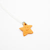 Orange star-shaped pendant on a white background