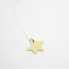 Yellow star-shaped pendant on a white background