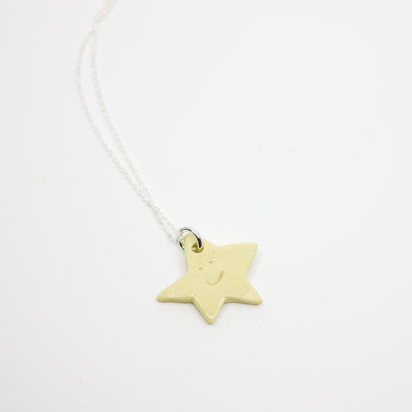Yellow star-shaped pendant on a white background