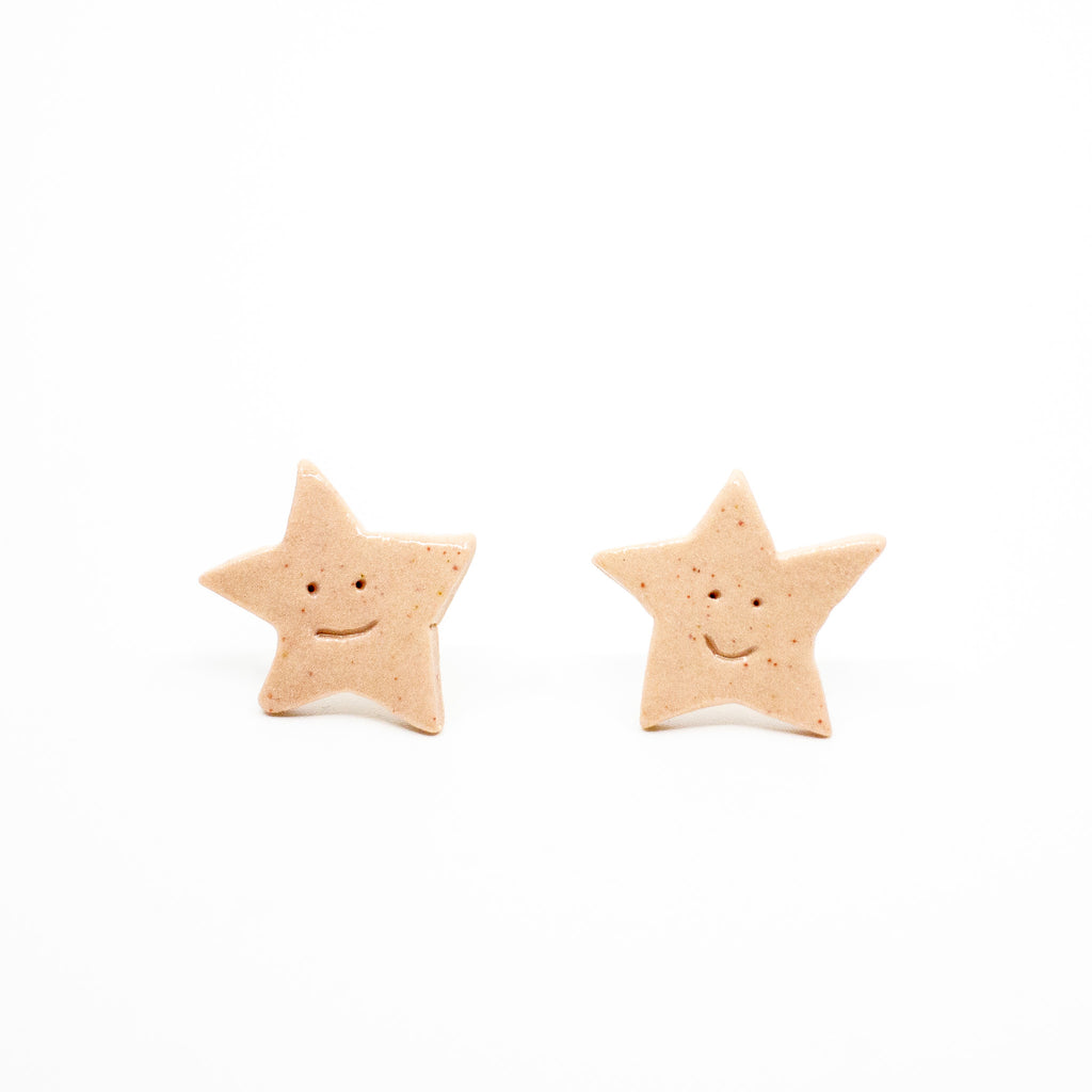 Star-shaped Earrings with smiling faces on a white background