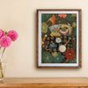 Framed artwork of two animals under a checkered blanket with flowers on a wall.