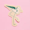 An illustrated sticker of a stilt with a beige outline against a pink backdrop. 