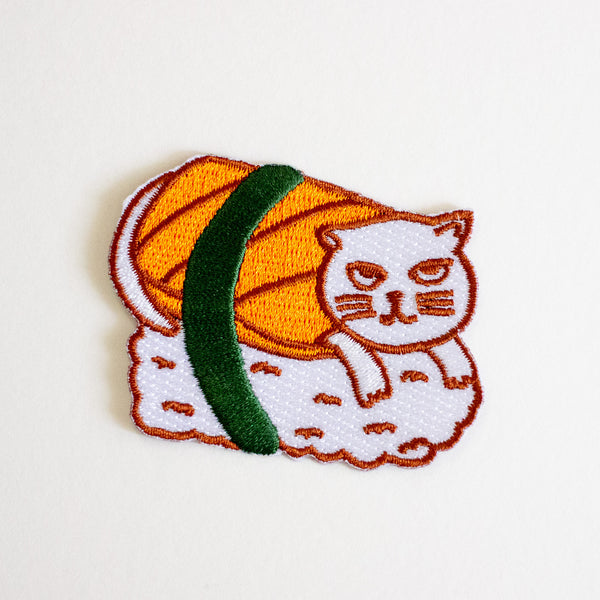 Embroidered patch of a cat-shaped sushi roll on a white background