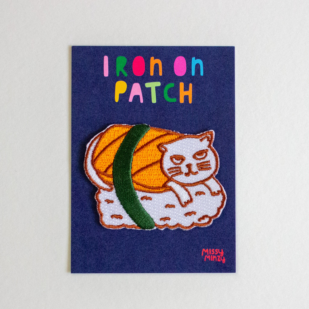 Sushi cat patch with colourful text on a blue card