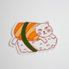 Sticker of a cat inside a roll of sushi with a green ribbon on a white background