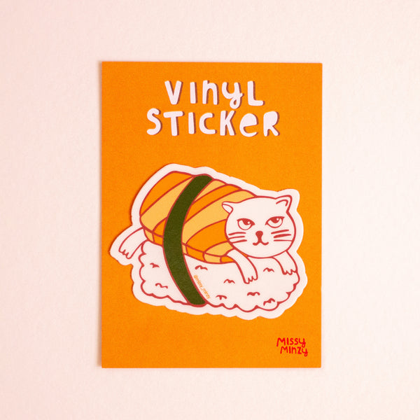Orange sticker with a cat-shaped sushi design and 'Vinyl Sticker' text on a beige background