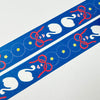 A close-up of a blue decorative strip with repeating white swan motifs, red ribbon bows, yellow stars, and small pink hearts on a white background.