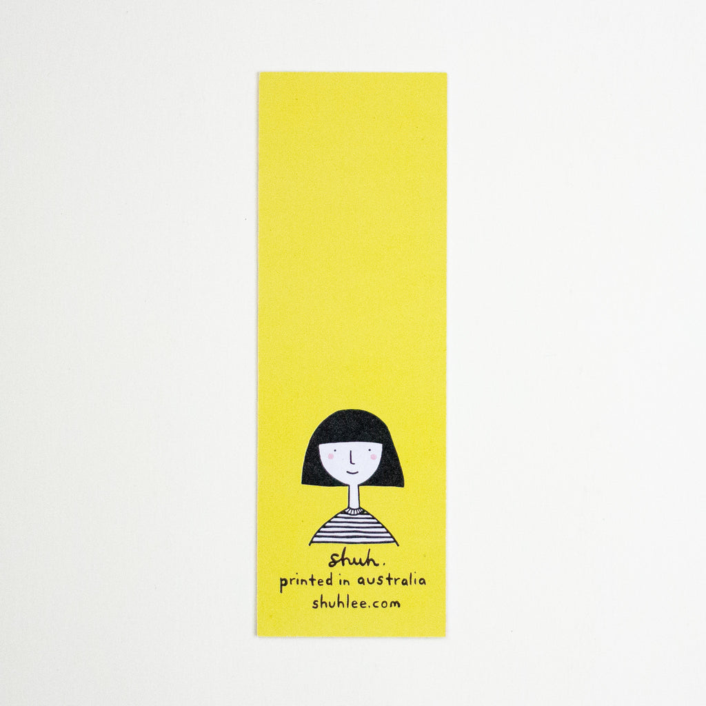 A tall, narrow yellow bookmark with a simple black line drawing of a person and the text 'shuh. printed in australia shuhlee.com'
