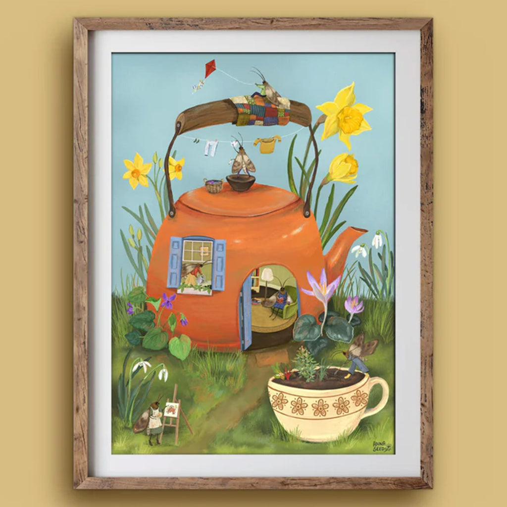 Framed illustration of a red teapot house with garden elements on a light green background
