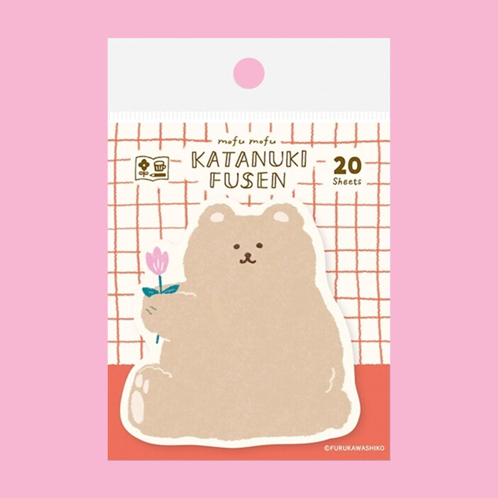 A package of cute bear-shaped sticky notes on a solid pink background. The notes feature a beige cartoon bear holding a small pink flower, with the text 'mofu mofu KATANUKI FUSEN 20 Sheets' on the packaging.